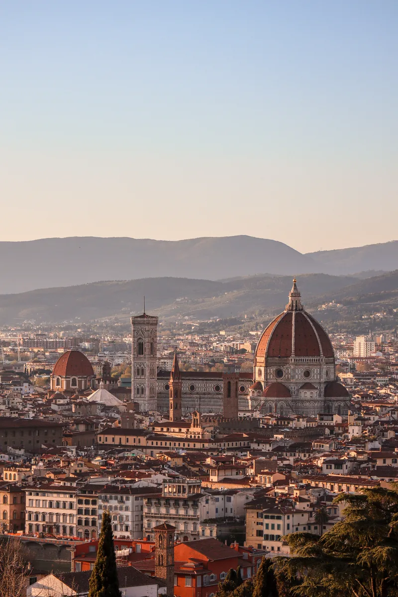 The skyline of Florence with the cathedral dome and bell towers at sunset