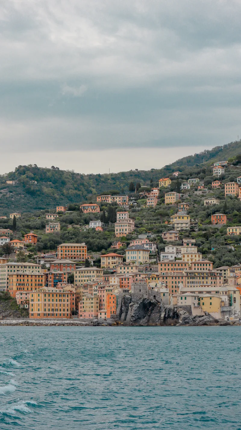 Camogli seen from the water, with houses climbing a green hillside