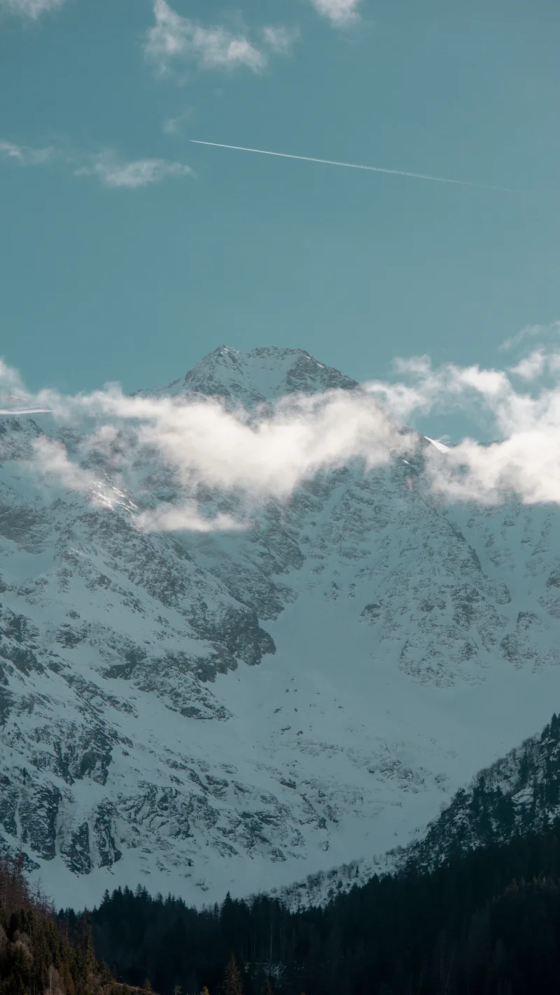 Snow-covered mountains with cloud drifting across the peaks