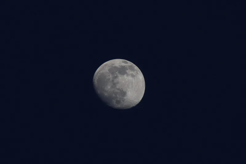 A full moon in a deep blue night sky