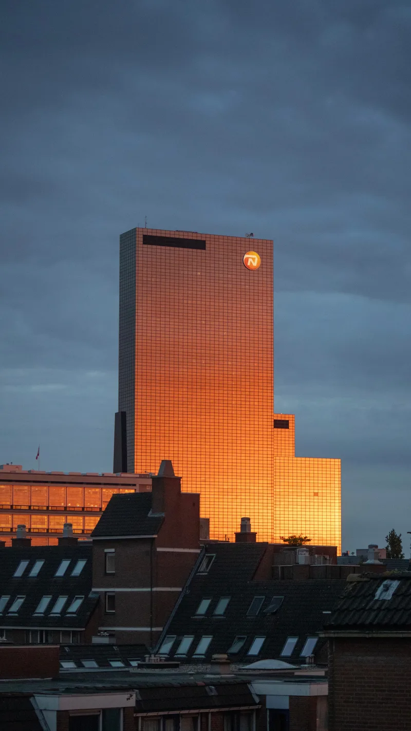 A tall copper-coloured tower lit by the evening sun