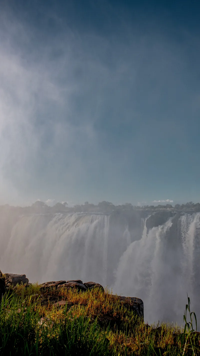 Spray rising from the falls under a blue sky